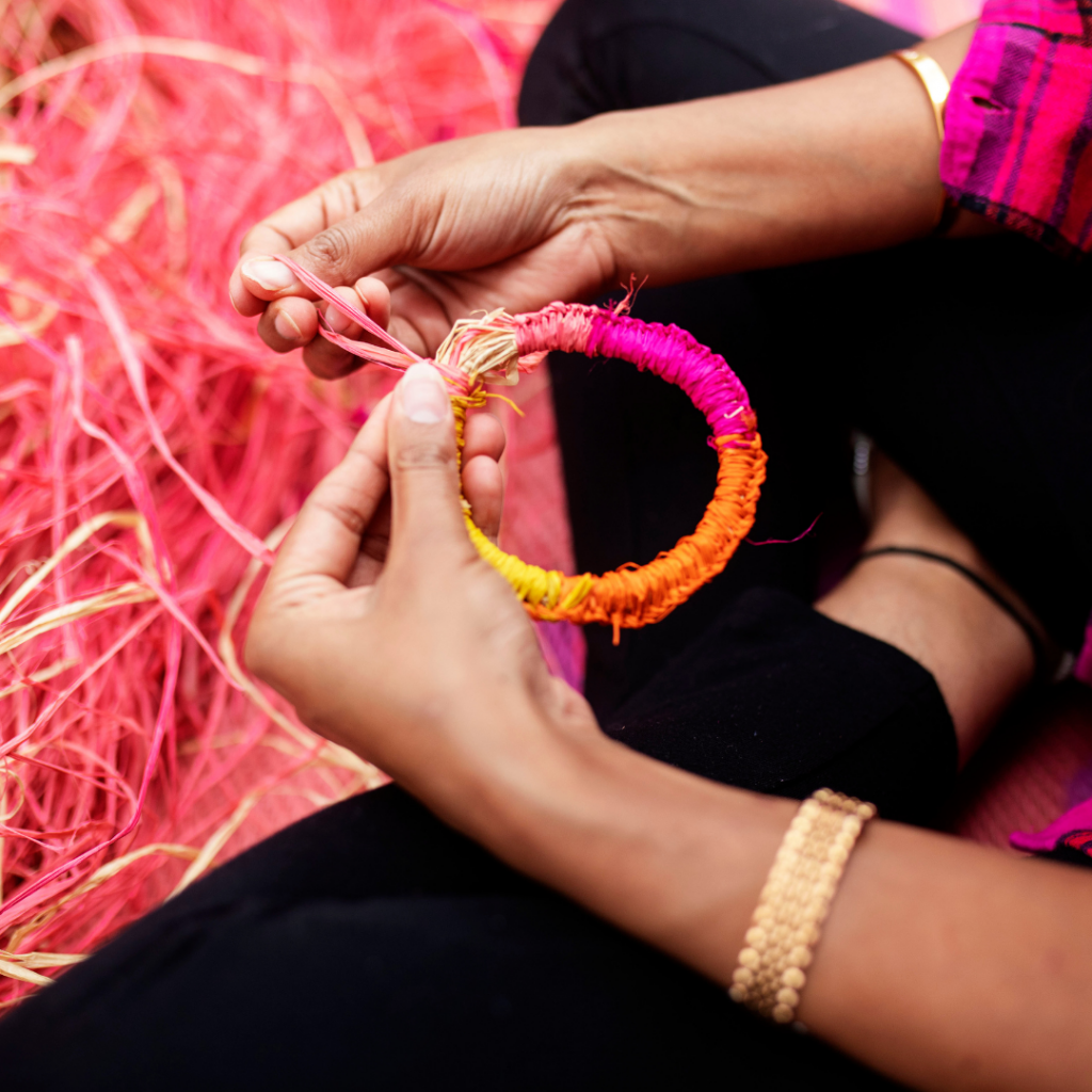 colourful string, showcasing weaving a bracelet in orange and pink colours