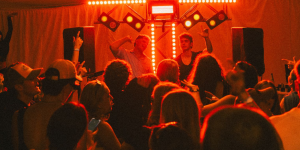 DJs playing to a crowd in red light